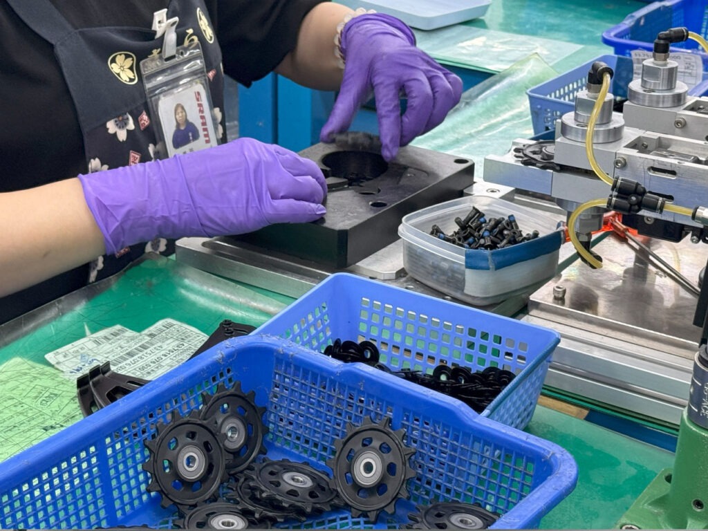 Person working on components in a factory